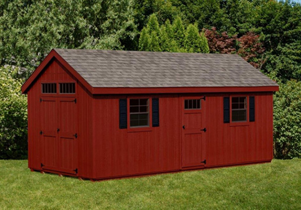 a red shed with a gray shingle roof