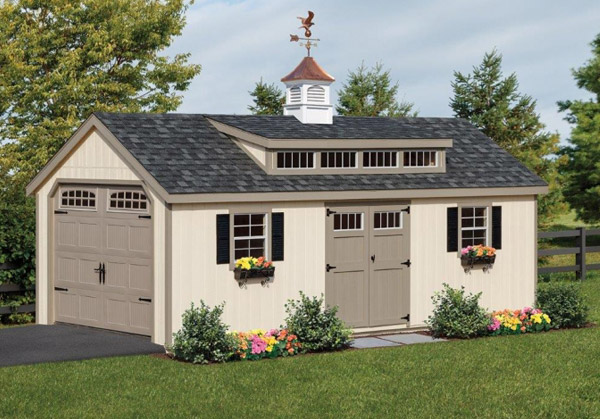 A gray single car garage shed with a weathervane on top of it