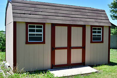 A white shed with red trim